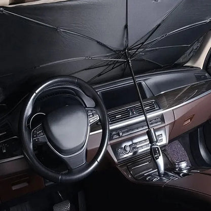 Car interior with a black umbrella covering the dashboard