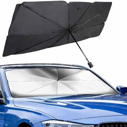 Black umbrella over a blue car with a sunshade on the windshield.