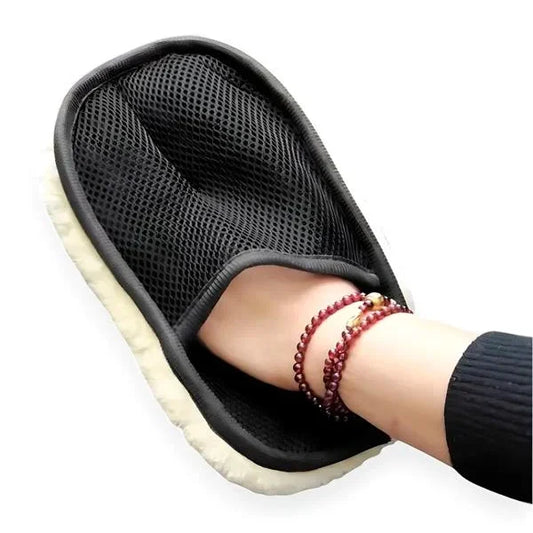 Black mesh slipper with a white sole worn by a person on a white background