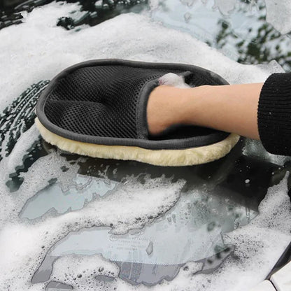 Person cleaning a car window with a soapy sponge